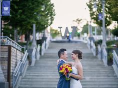 a bride and groom are standing on the stairs