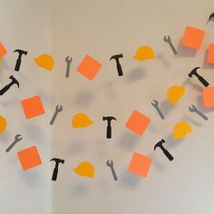 construction themed party decorations with hammers and orange sticky notes attached to the wall above them