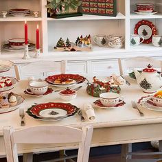 a dining room table set for christmas dinner