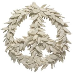 a white wreath made out of leaves on a white background