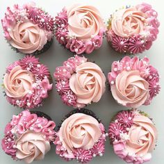 cupcakes with pink frosting and flower decorations