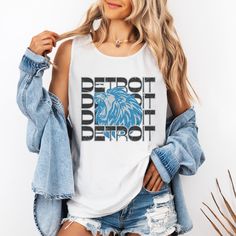 This Detroit Football shirt has a retro vibe with a fun Lions Football inspired graphic. Celebrate Football Season with game day shirt that you will want to wear on repeat. Comfort Colors are the most popular and trending shirts right now. This shirt will soon be your favorite with fabric created to be softer and feel broken in. The elevated dyeing process reduces shrinking up to 99% and the shirt is made from 100% ring spun cotton. - M A T E R I A L S - 100% Ringspun US cotton Medium fabric (6. Summer Fan Gear Graphic Tee Tops, Summer Fan Gear Graphic Tee, Summer Graphic Tee Tops For Fans, Slogan Sleeveless Top For Streetwear, Sleeveless Slogan Tops For Streetwear, Sleeveless Graphic Print Top For Game Day, Sleeveless Cotton Tops For Game Day, Retro Letter Print Tank Top, Casual Sleeveless Muscle Tee With Screen Print