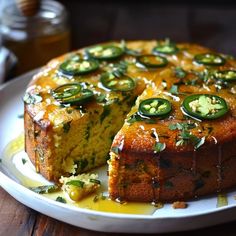 a cake on a plate with slices cut out and sauce drizzled over it