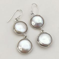 Behold the captivating beauty of these Elegant Freshwater Coin Pearl 925 Solid Sterling Silver Handmade Dangle Drop Earrings. Each earring features a lustrous freshwater coin pearl, its smooth surface catching and reflecting the light in a mesmerizing dance. Suspended from delicate sterling silver chains, these earrings add a touch of timeless elegance and gentle sophistication to any ensemble. More than just pearls, a whisper of timeless allure: Freshwater coin pearls, with their unique flat shape and mesmerizing sheen, symbolize wisdom, grace, and enduring beauty. These earrings become a whisper of confidence, reminding you to embrace your inner radiance and let your gentle shimmer captivate the world around you. Whether you're drawn to classic styles, a touch of vintage glamour, or simp Hallmarked Sterling Silver Dangle Pearl Earrings, Sterling Silver Pearl Earrings For Anniversary, Fine Jewelry Sterling Silver Pearl Dangle Earrings, Sterling Silver Dangle Pearl Earrings For Anniversary, Handmade Drop Pearl Earrings In Sterling Silver, Handmade Sterling Silver Round Pearl Earrings, Handmade Sterling Silver Drop Pearl Earrings, Handmade Round Sterling Silver Pearl Earrings, Silver Dangle Pearl Earrings Fine Jewelry