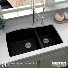 a double black kitchen sink sitting on top of a counter