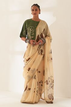 Whole wheat beige pure linen handloom saree with all-over multi colored floral patterns prints. Comes with contrast unstitched blouse piece.
Components: 2
Pattern: Printed
Type Of Work: Floral
Fabric: Pure Linen
Color: Beige
Other Details: 
Scalloped hem saree
Tassel edged palla
100 count handcrafted linen base
Dimensions:
Width: 45 inches
Length: 5.5 mtrs
Note:
The unstitched blouse is same as shown in the image.
The stitched blouse and all the jewellery worn by the model is not for sale.
Occas Saree Tassel, Draping Styles, Long Blouse Designs, Saree Painting Designs, Simple Saree Designs, Khadi Saree, Saree Draping, Simple Sarees, Unique Blouse Designs