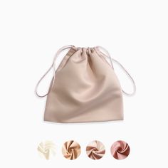 three different colors of satin drawsacks in various shapes and sizes, including one with two