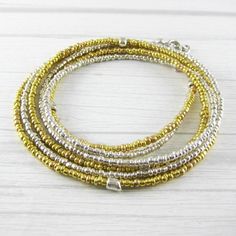 6 layer wrap bracelet/ two strands that wrap around three times/ glass seed beads in shiny gold and silver/ made with flexible coated wire and a lobster clasp/ adjustable/ fits 6.5-7.5 inch wrist/ convertible/ can also be worn unwrapped as a double-strand necklace more wrap bracelets: https://www.etsy.com/shop/CabanaCraftroom?section_id=32714534 Multi-strand Wrap Bracelet With Faceted Beads, Adjustable Nickel-free Brown Wrap Bracelet, Adjustable Brown Multi-strand Wrap Bracelet, Silver Bohemian Multi-strand Wrap Bracelet, Bohemian Brown Hand-strung Wrap Bracelet, Silver Wrap Bracelet, Everyday Bracelet, Double Strand Necklace, Gold And Silver