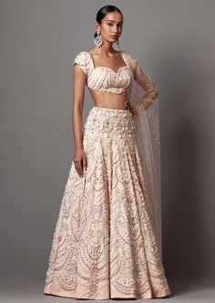 750 hours of handwork in lehenga with pearls and silver embellishments paired with hi-shine beaded blouse and dupatta. 100% handwork only. Elegant Pearl Embroidered Lehenga For Festivals, Elegant Lehenga With Pearl Embroidery For Festivals, Designer Raw Silk Lehenga With Pearl Embroidery, Semi-stitched Hand Embellished Raw Silk Lehenga, Designer Pearl Embroidered Lehenga For Festivals, Traditional Drape Raw Silk Lehenga With Pearl Embroidery, Traditional Fitted Lehenga With Pearl Embroidery, Designer Hand Embellished Raw Silk Choli, Designer Wear Hand Embellished Raw Silk Choli