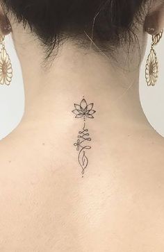 the back of a woman's neck with a tattoo on it