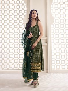 This great winter ensemble from Malaika Arora is perfect for your next special occasion. It includes a bottle green kurta set crafted from silk blend brocade, cotton and organza. Featuring Zari woven designs, a U-neck and calf length trousers, this set is sure to make a statement. It is dry clean only and designed specifically by the Bollywood Diva herself. TOP: Silk Blend(Brocade), TOP INNER: Cotton, BOTTOM: Cotton, DUPATTA: Organza, Dry Clean Cotton Suit Designs Sleeveless, Green Suit Designs Indian Style, Short Kurta Suits Women, Bottle Green Suits Women Indian, Brocade Kurta Set, Green Kurta Set Women, Kurta Designs Women Sleeveless, Trendy Suit Designs For Women, Blouse Back Ideas