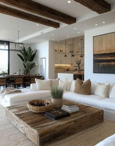 a living room filled with furniture and a large painting hanging on the wall above it