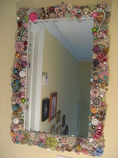 a mirror that has been decorated with beads