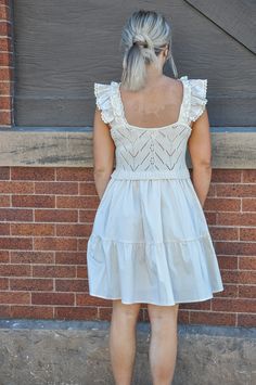 The Ruffled Sleeves Sweater Top Combo Dress in a natural color is a beautifully crafted garment that merges the coziness of a sweater with the elegance of a dress. This piece is designed to offer a seamless look that combines two distinct styles into one harmonious outfit, making it a unique addition to any wardrobe. The top portion of the dress features a sweater-like fabric that is soft and comforting, perfect for cooler days. It is distinguished by its eye-catching ruffled sleeves which add a Beige Cotton Mini Dress With Ruffle Hem, Cottagecore Mini Dress With Ruffles For Daywear, Casual Cream Mini Dress With Ruffles, Off White Ruffled Casual Mini Dress, Casual Off White Mini Dress With Ruffles, Off White Cotton Mini Dress With Ruffles, Casual Off-white Ruffled Mini Dress, Casual Off-white Ruffled Dress, Beige Cotton Mini Dress With Lace Trim