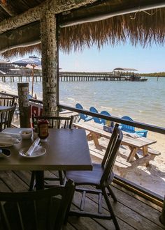 tables and chairs are set up on the beach