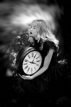 a woman holding a clock in her hands