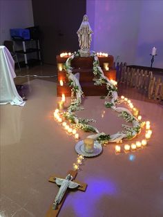 a cross and some candles on a table