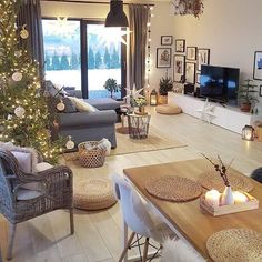 a living room filled with furniture and a christmas tree in front of a large window