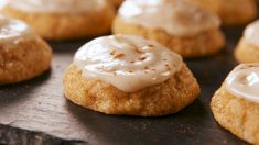 some cookies with icing are sitting on a baking sheet and ready to be eaten