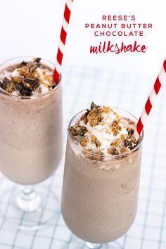 two glasses filled with milkshakes on top of a table