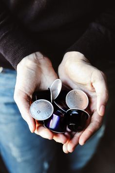 a person holding three cups in their hands