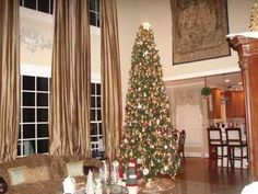 a living room filled with furniture and a christmas tree