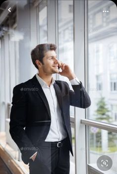 a business man talking on his cell phone in an office building - stock photo - images