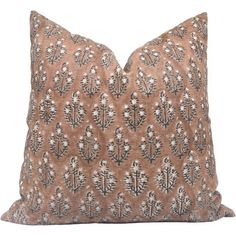 a brown and white pillow with an intricate design on the front, sitting on a white background