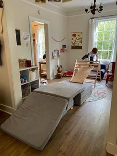 a child is playing on a bed in the living room