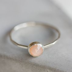 Tiny skinny stackable ring with beautiful Peach Moonstone. It is made with a skinny but sturdy band, perfect for everyday wear. It is a gentle and delicate piece, which you may wear alone or stacked. It is a great every-day jewel which will perfectly suit any occasion and any outfit. The ring is 0,8-0,9 mm thick and looks very dainty on the finger. Choose the size of the stone (3 or 5 mm) and material for the ring (sterling silver or 9k gold). If you want to change the ring band design or get a Stackable Minimalist Moonstone Ring, Adjustable Stackable Moonstone Promise Ring, Dainty Stackable Sterling Silver Opal Ring, Stackable Moonstone Promise Ring Jewelry, Dainty Stackable Moonstone Jewelry, Silver Moonstone Stackable Rings, Dainty Silver Opal Stackable Ring, Dainty Silver Stackable Opal Ring, Dainty Adjustable Moonstone Ring For Everyday