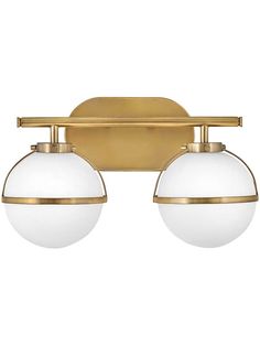 two light bathroom fixture in an antique brass finish with white glass balls on the sides