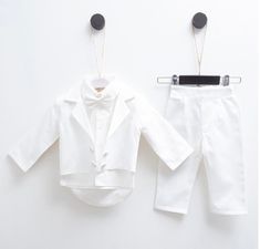 two pieces of white clothing hanging on clothes pins