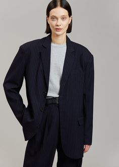 Color: Navy Pinstripe Midweight traditional suiting fabric Oversized silhouette Padded shoulders Flap front pockets Button front closure Lined 72% Polyester 22% Rayon 4% Wool 2% Spandex Dry Clean By The Frankie Shop. Imported One Size Product Measurements: 20" Shoulder 46" Bust 30" Length Model is wearing size O/S Navy Blue Blazer Outfit, Blue Blazer Outfit, The Frankie Shop, Suiting Fabric, Navy Blue Blazer, Frankie Shop, Navy Suit, Navy Blazer, Womens Blazers