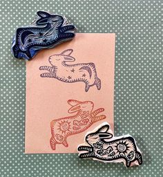 three different colored animal magnets sitting on top of a piece of paper