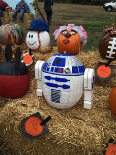 star wars themed pumpkins are on display in the hay