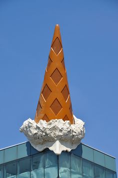 an ice cream cone on top of a building