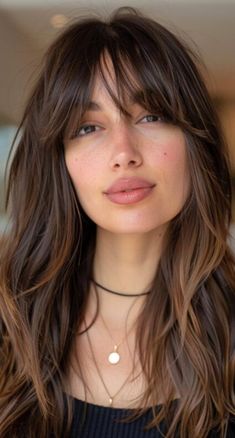 Discover 28 stylish long haircuts with bangs, from subtle, fine fringes to thicker, bolder bangs. Each style offers a unique way to enhance your long hair. Longer Fringe Bangs, Long Face Bangstyle, Spy Bangs Hair, Medium Length Hair Bangs Layers, Thick Long Bangs, Long Hair With A Fringe, Long Thick Hair Bangs, Long Bob Haircuts With Fringe, Middle Parting Fringe