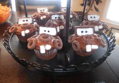 some cupcakes with chocolate frosting in the shape of animals