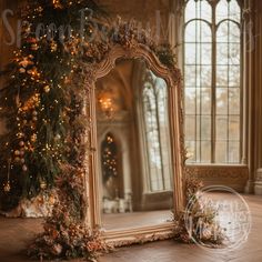 a mirror sitting on top of a wooden floor in front of a christmas tree with lights