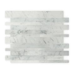 a white marble tile wall that has been made from several different types of carrinine