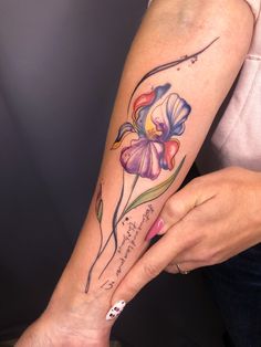 a woman with a flower tattoo on her arm