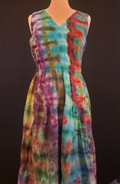 Medium ladies ice dye dress. Lovely tiered festival-style dress in a rainbow of colors. Soft and feminine tie dye. Zipper on the side.  I use only the finest quality fiber reactive procion dyes from Dharma Trading Company, so the colors will last for years to come. You can safely wash this in the washing machine. It has been laundered twice in the dye process. I have done tie dye for years, but the pandemic gave me the opportunity to really delve into the craft, and I have found that I really enjoy ice dye. My Barcardi Kitty probably helped me tie your item, as she can't resist the kite string I use. I call her my artistic mews (get it? muse).  My items are dyed one at a time by me. These are not mass produced items being resold. I try to find the best quality, but affordable, blanks I can Festival Mode, Style Festival, Buy Clothes Online, Ice Dye, Dye Dress, Festival Style, Ice Dyeing, Dyed Dress, Festival Dress