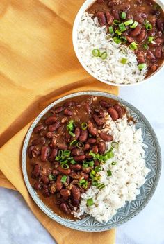 two bowls filled with rice and beans on top of a table