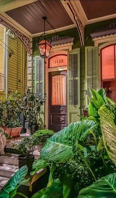 the front porch of a house with potted plants