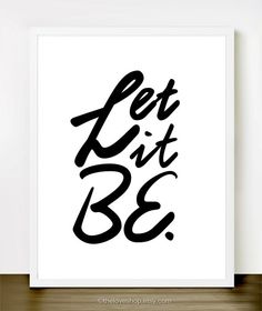 a black and white poster with the words let it be in cursive font