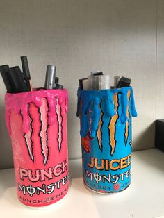 two cans that have toothbrushes in them