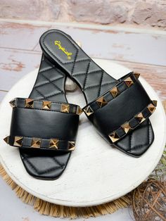 Introducing the Sutton Studded Sandal in Black. This sleek slide sandal features stud detailing and a quilted cushion footbed for added comfort. Perfect for adding a touch of edginess to any outfit. Brand: Qupid Sizing suggestion: true to size fit Model: wearing her true size 8 Quilted Cushion, One Piece Jumper, Kids Activewear, Layered Sweater, Studded Sandals, Jean Accessories, Sandals Black, Skirt Leggings, Black 7