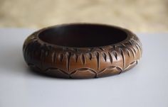 Vintage chunky plastic brown bangle bracelet, from the 80s / 90s era The bangle is made to resemble a bone bangle with purposefully made scratches and imperfections and fading of the brown color into beige Approx. measurements: Diameter (on inside) - 2.65 inches / 6.75 cm Height - 0.85 inches / 2.2 cm Condition: Very good vintage condition! Handmade Brown Bohemian Bangle, Handmade Bohemian Brown Bangle, Traditional Handmade Brown Bangle, Bohemian Handmade Brown Bangle, Brown Carved Bangle Bracelets, Vintage Carved Brown Bracelets, Vintage Brown Carved Bracelets, 80s Costume, Vintage Bangle Bracelets