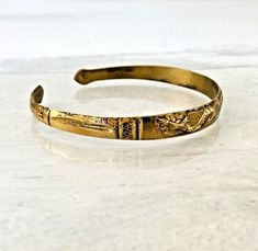 Vintage Raised Dragon Cuff Bracelet Gold Tone Brass Vintage Possibly Siam Made Great detail and workmanship which extends from the dragon itself to the shape of the ends of this cuff. Open ended and flexible, it can be slightly shaped to an oval to better fit your wrist. It is almost round. The cuff is 5/16 inch (9mm) wide at the center, and 7 1/4 inches long plus the 3/4 of an inch opening. In very good condition with light signs of wear. It is estimated to date from the early to mid-20th Centu Adjustable Ceremonial Bangle Cuff Bracelet, Adjustable Cuff Bangle For Ceremonial Occasions, Ceremonial Adjustable Metal Bracelets, Unique Adjustable Ceremonial Bracelets, Unique Ceremonial Adjustable Bracelet, Unique Adjustable Bracelets For Ceremonial Occasions, Medieval Style Bangle Bracelet As Gift, Adjustable Cuff Bracelet With Lost Wax Casting For Gift, Antique Adjustable Cuff Bracelet Gift