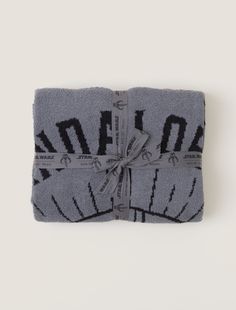 Show your love for the best bounty hunter in the galaxy with our new Mandalorian™ blanket. Knit detailing shows the Mandalorian's iconic helmet while the jacquard pattern creates an extra cozy feel, making it the perfect piece to snuggle up with while watching all your favorite Star Wars™ moments. Packaged and tied with custom Star Wars ribbon, this item is perfect for gifting.   This style is not eligible for promotional discounts. Disney Blanket, Star Way, Pet Sweaters, Star W, Elegant Drapes, Pink Clay, Sleep And Loungewear, Cozy Pullover, Jacquard Pattern